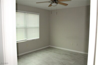 Unfurnished room with baseboards and a ceiling fan