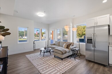Living area with dark wood-style flooring and recessed lighting