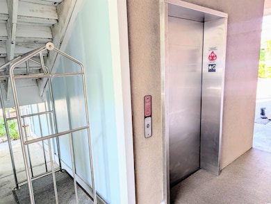 Details with carpet flooring and elevator