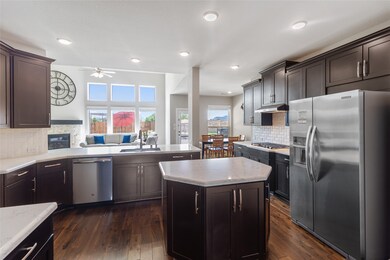 This kitchen is by far any chef’s dream! This spacious kitchen features large windows, high ceilings, dark stained wood cabinets, granite countertops, SS appliances, modern tile backsplash, recessed lighting, extended counter space, separate island, and a walk-in pantry all overlooking your huge family room and breakfast area.