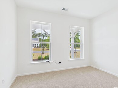 Carpeted spare room with baseboards