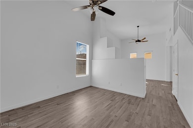 Unfurnished room featuring  a towering ceiling, and ceiling fan