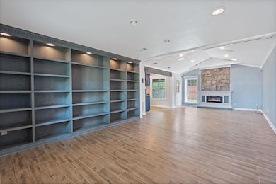 Unfurnished living room featuring baseboards, rec