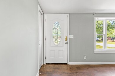 Foyer entrance featuring dark wood-type flooring