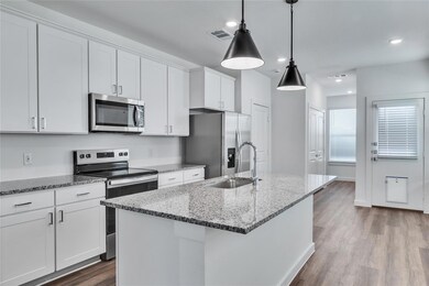 Kitchen with visible vents, a kitchen island with 