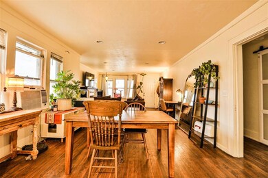 Dining room featuring a barn door and dark hardwoo