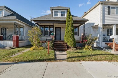 Bungalow-style house featuring roof with shingles, a front lawn, and a porch