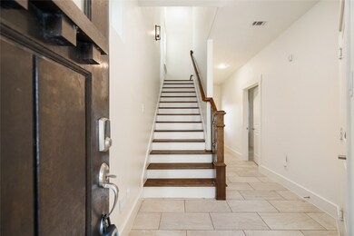 Foyer entry with stylish tile floors and wood-acce