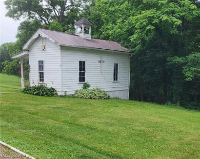 View of property exterior with a lawn