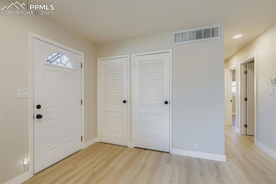 Entry with coat closet and utility room