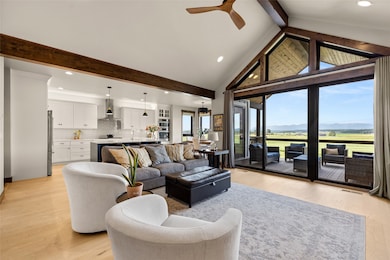 Living room featuring light wood-type flooring, beam ceiling, ceiling fan, recessed lighting, and high vaulted ceiling