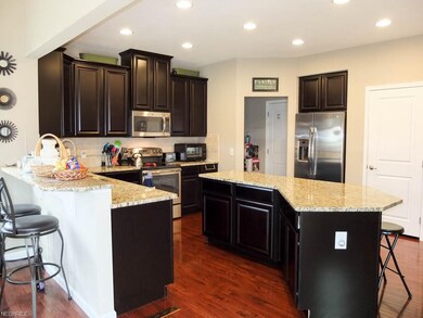 Kitchen has a large center island, granite counter