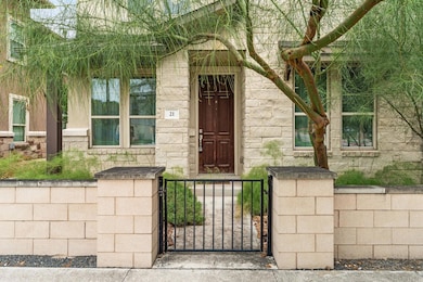 Entrance to property with stone siding and a gate
