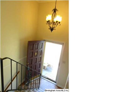 The split foyer with a new chandlier and wrought i