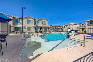 Community pool featuring fence, a patio, and a res