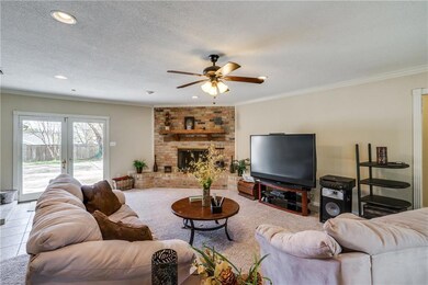 Living area features corner wood burning fireplace