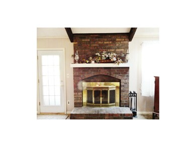 Classic brick fireplace with walk out to deck.
