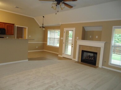 Open greatroom with high ceilings, new carpet, neutral paint, fireplace with gas logs