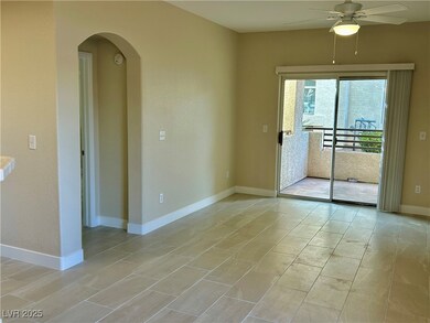 Empty room featuring baseboards, a ceiling fan, an