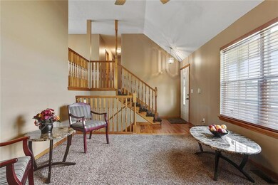 View toward the stairs from the fireplace. Hardwoo