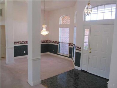 View of formal dining room with trey ceiling & elegant chandelier.