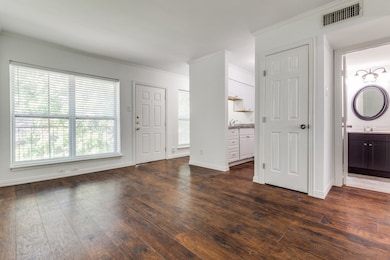 Entryway with ornamental molding and dark wood-type flooring