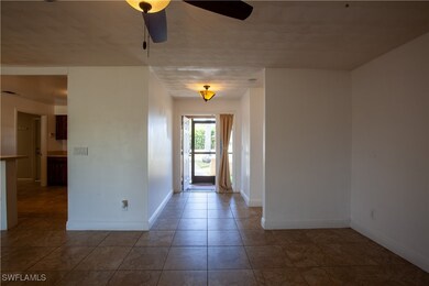 Entryway with a ceiling fan, baseboards, and tile