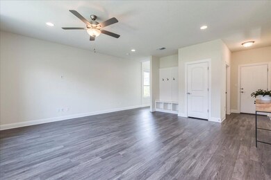 Spare room featuring ceiling fan, visible vents, 