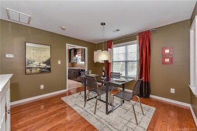 dining room w/hardwood floor & custom lighting