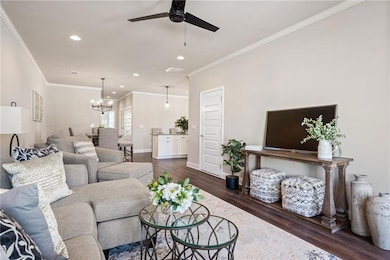 Living room featuring ornamental molding, dark har