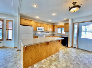The vinyl maintenance free floor is so easy to clean. You'll love this bright cheerful kitchen.