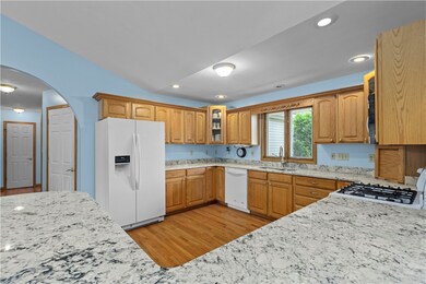 GRANITE COUNTERS, HARDWOOD FLOORS AND AN ABUNDANCE OF CABINETS CAN BE FOUND IN THE FULLY EQUIPPED KITCHEN