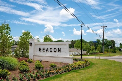 Community / neighborhood sign featuring a yard