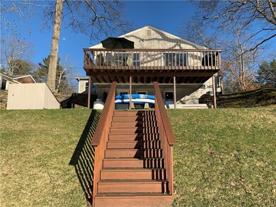 Back of house on waterside with stairs that lead d