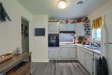 The nice-sized kitchen with newer glass cooktop and wall oven.