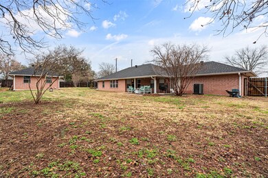 Back of house featuring central AC and a lawn