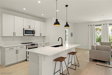 Kitchen featuring sink, white appliances, white ca