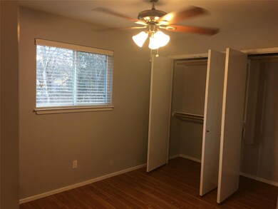 Unfurnished bedroom featuring dark wood-style flo