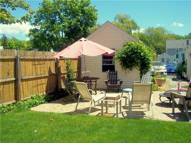 Exterior Back. Patio and 1-car garage.