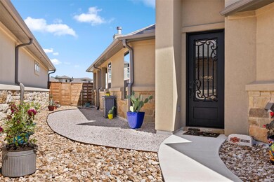 Doorway to property featuring fence and stucco si