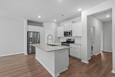 Kitchen featuring stainless steel appliances, a si