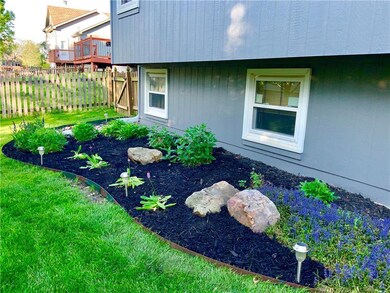 Gorgeous landscaping continues around the back of 
