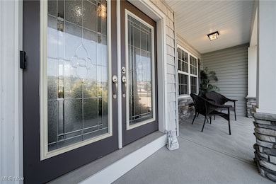 View of exterior entry with covered porch