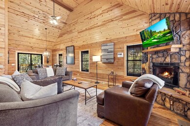 Living room featuring high vaulted ceiling, wooden
