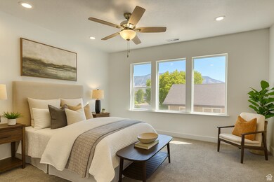 Bedroom with light colored carpet, ceiling fan, recessed lighting, and a mountain view