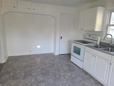 Newer countertop, stainless steel sink and floorin