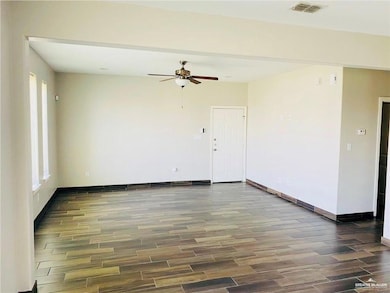 Unfurnished room with wood finished floors and a ceiling fan