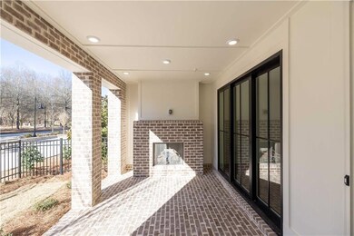 The covered patio features a beautiful brick floor and cozy fireplace.
