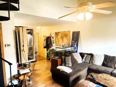 Living room featuring a ceiling fan and wood finis