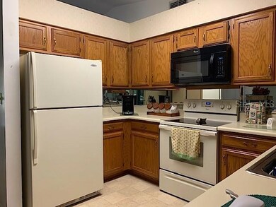 Kitchen features Whirlpool appliances and mirrored
